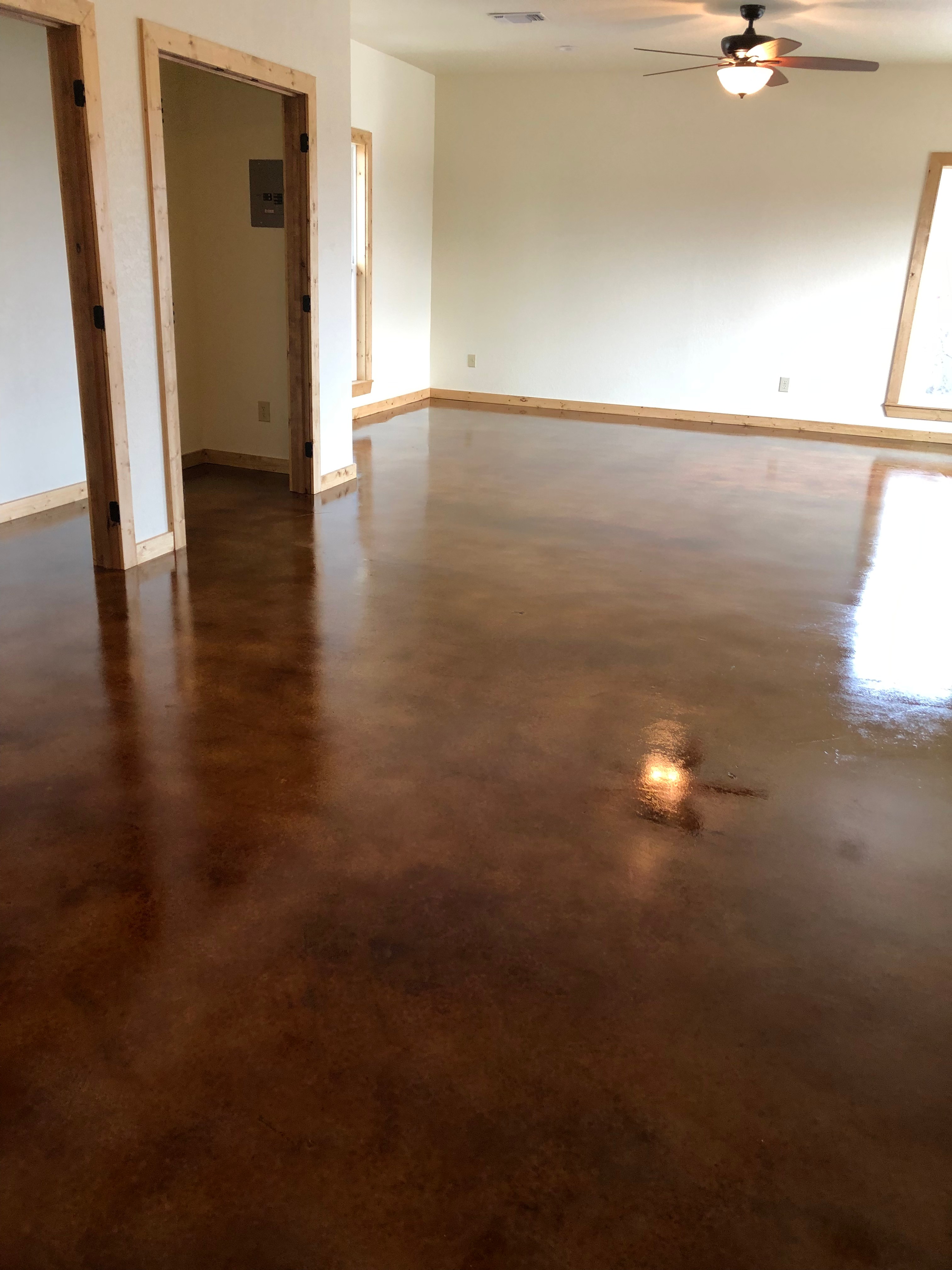 Beautifully finished acid-stained concrete floor with rich dark mahogany gloss sealer by R.G. Pro Floors in Brownwood TX